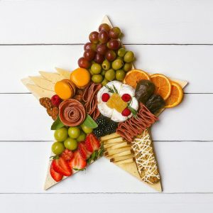 star-shaped charcuterie board with artisan meats cheese and fruit